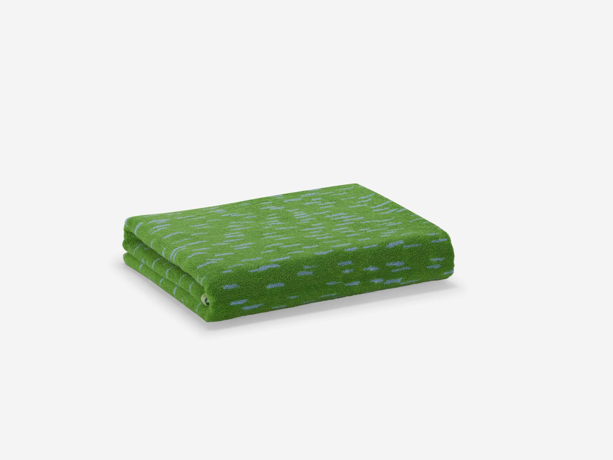 Front angle view of folded green spotted bath towel